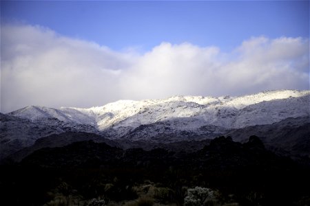 Snow over desert mountains photo