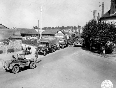SC 195731 - Express convoy moving forward with supplies while the returning empties are being held back along with truckload of French refugees returning to their homes near Rozay, France. 15 September, 1944. photo