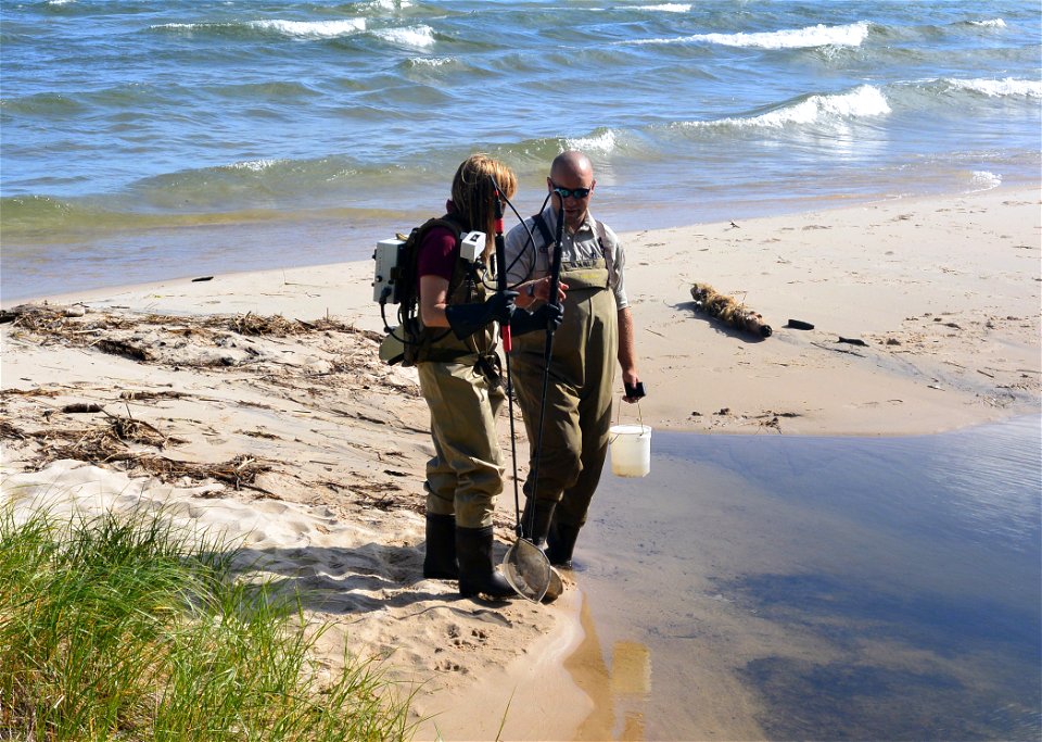 Nik Rewald, Biological Science Technician, teaches Joanna Gilkeson, Public Affairs Specialist, how to electrofish for sea lamprey in Pendills Creek in upper Michigan.