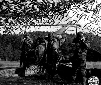SC 196134 - Members of the gun crew hold their ears as an 8 inch howitzer sends a 200 pound shell over into an enemy position on the Belmont sector, France. 31 October, 1944. photo