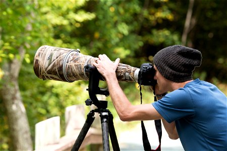 Photographer with Camera and Tripod photo