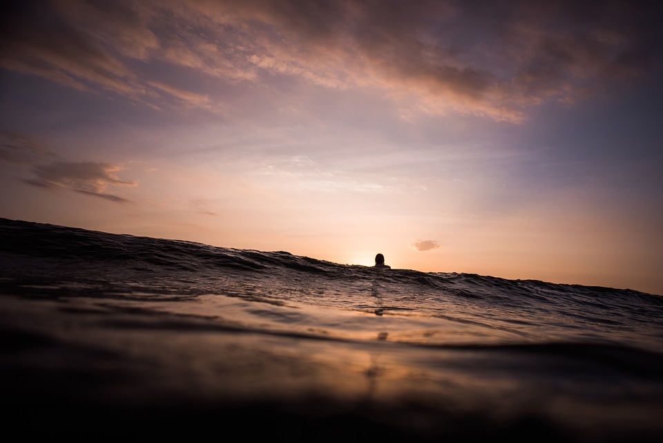 Surfer at Sunset Waiting for Waves