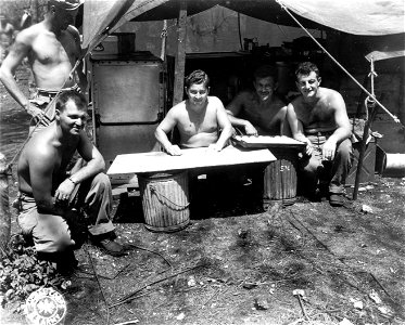SC 335370 - Illinois men watch other Illini make biscuits, following the battle on Saipan. photo