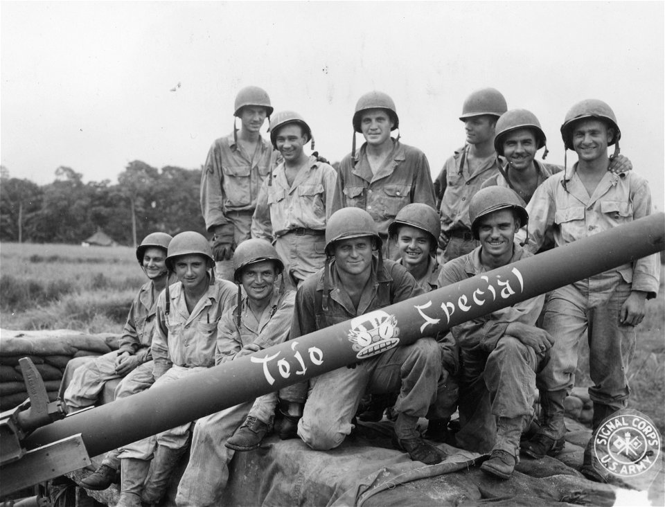 SC 334885 - Men of B Btry., 163rd AAA Bn., grouped around the barrel of their 90mm AA gun named "Tojo Special".