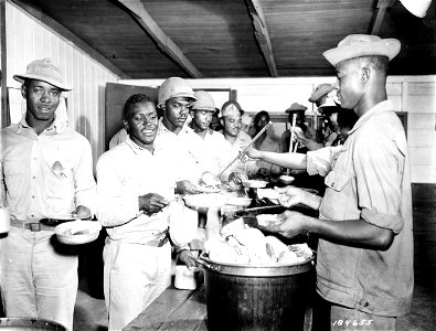 SC 184655 - It's chow time at an Air Base Security Bn. in the South Pacific Area. 29 June, 1943. photo
