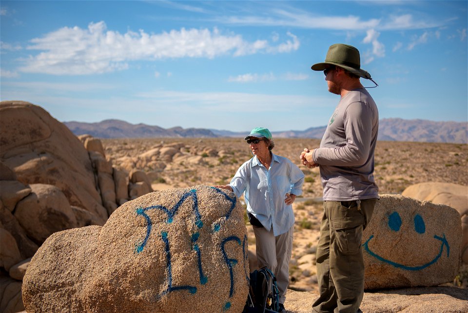 Rangers Discussing Graffiti Removal With Volunteers