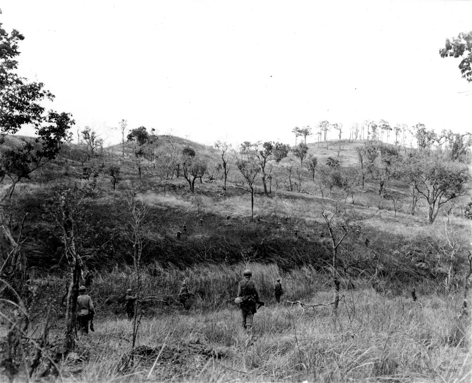 SC 270701 - Infantrymen of I Co., 20th Inf., 6th Div., advance up the side of a hill on the Kebayashi Line near Manila, Luzon P.I. 14 March, 1945.