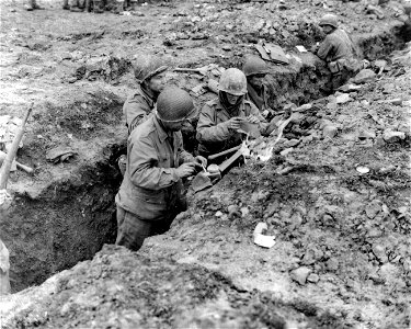 SC 396852 - Eating "K" rations in trench near 94th Division front in Germany are: photo