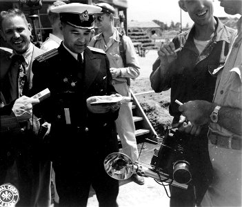 SC 405054 - U.S.S.R. naval attache in Japan. Commodore Anatoly Radionov passes out Russian cigarettes to press men at Atsugi strip, Tokyo. 30 August, 1945.