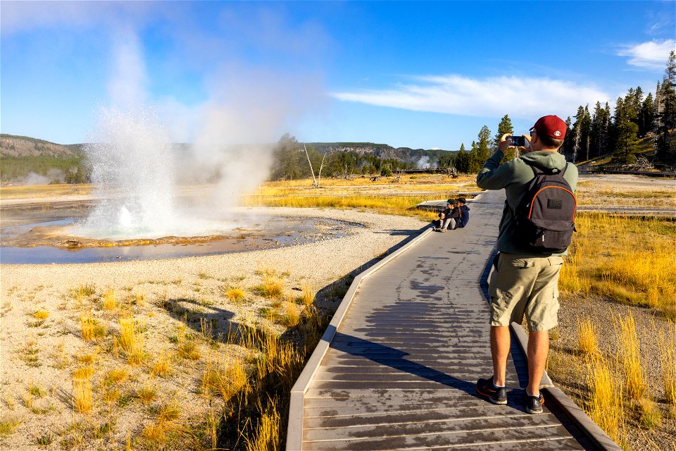 Family watching Sawmill Geyser erupt from boardwalk