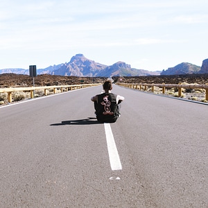 Man in Road and Mountains photo