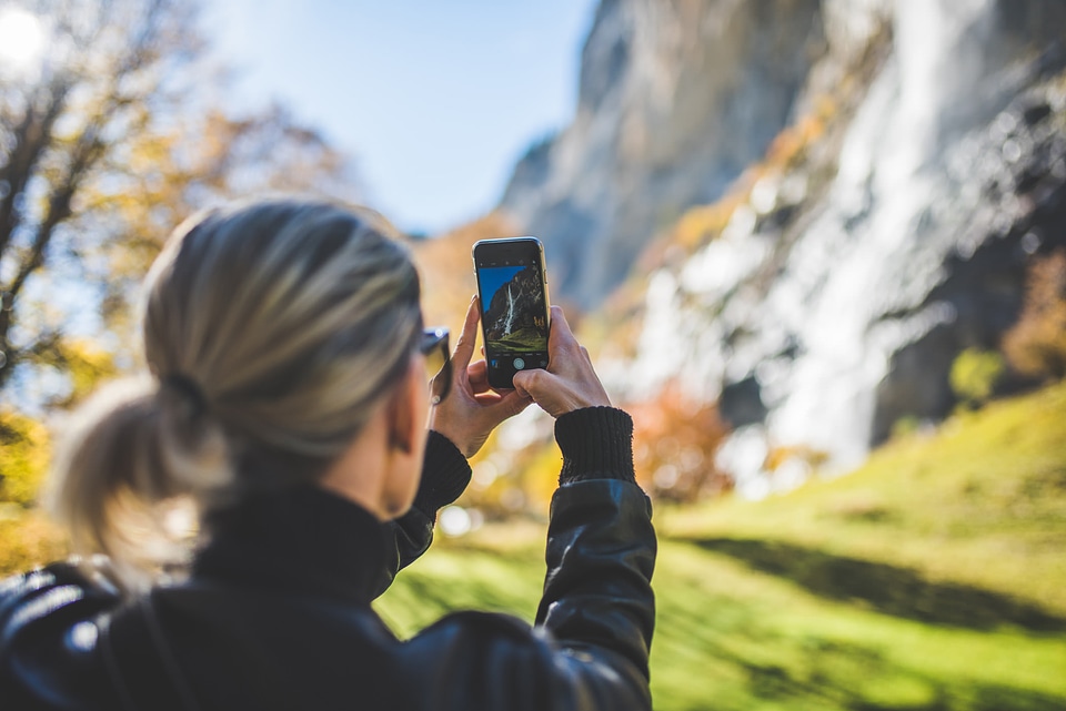 Woman Taking Mobile Photograph