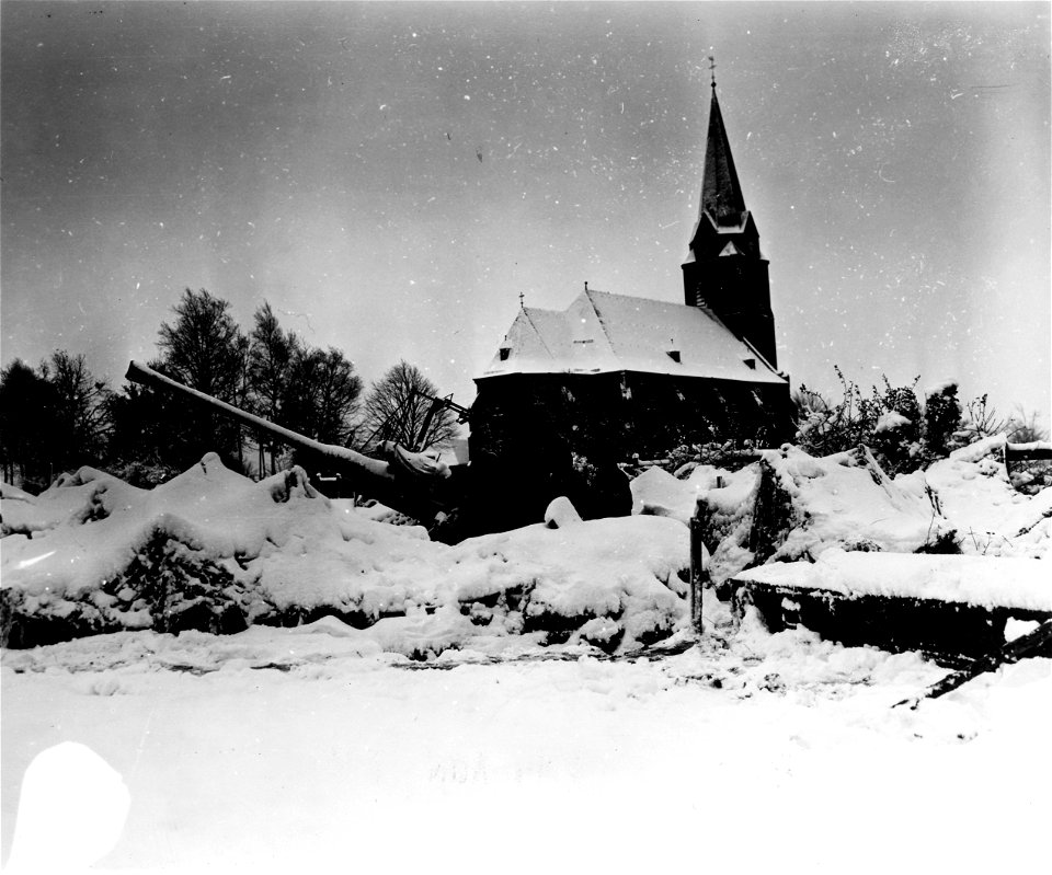 SC 196240-S - GIs of an ack-ack battery man their gun in a Belgian church yard, during the first snowfall. Belgium, 9 November, 1944.