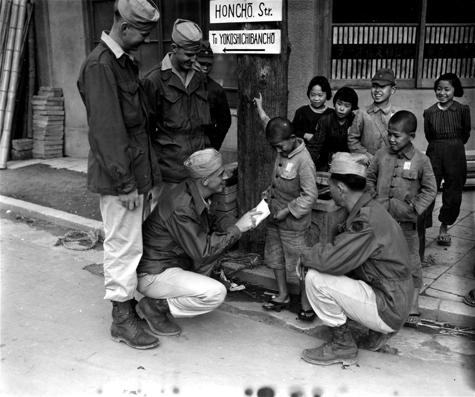 SC 221506 - GIs of the 27th Div question little Jap boy about street directions in Nigata, Honshu, Japan.