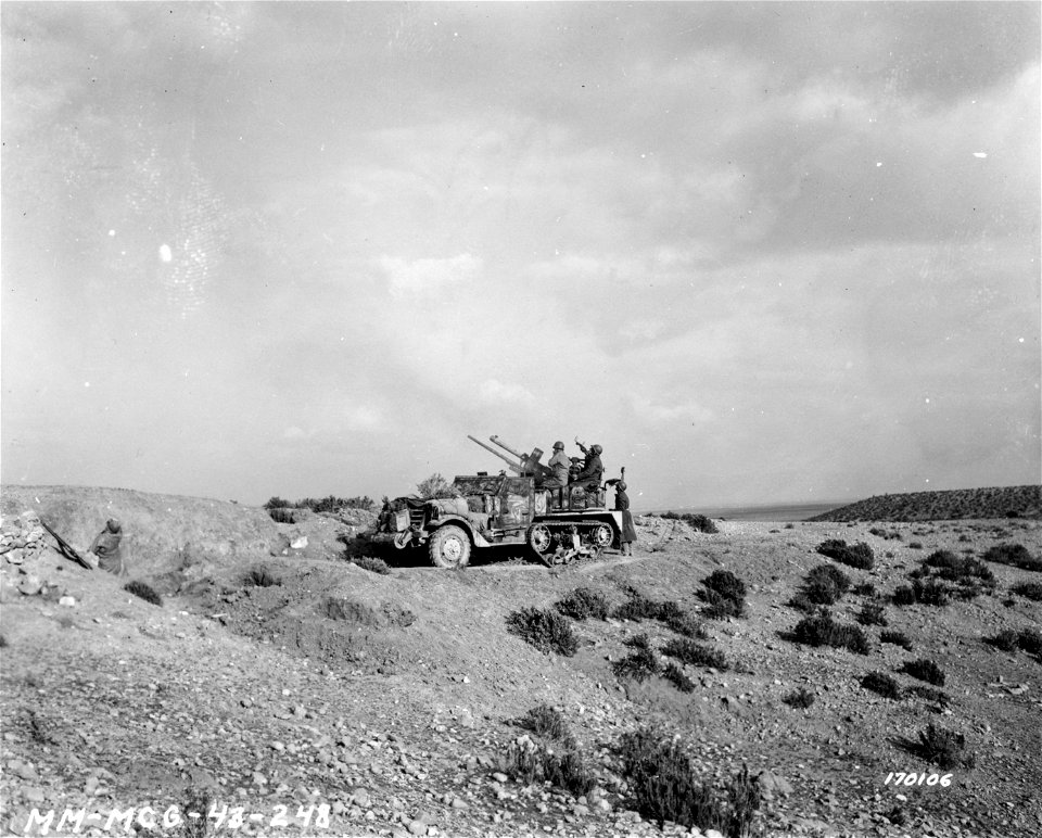 SC 170106 - The crew of an anti-aircraft guns in half-track await orders to commence firing on approaching bomber aircraft. 24 February, 1943.