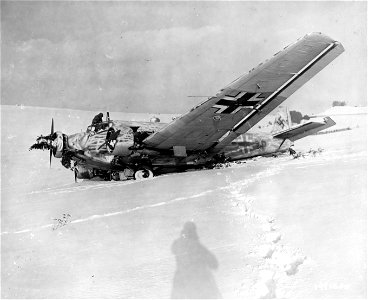 SC 199060-S - An American soldier examines the wreckage of a German Ju-52 that was knocked down by anti-aircraft fire one kilometer south of Asselborn, Luxembourg. 22 January, 1945. photo