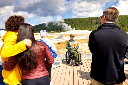 Ranger giving a program on the boardwalk at Old Faithful photo