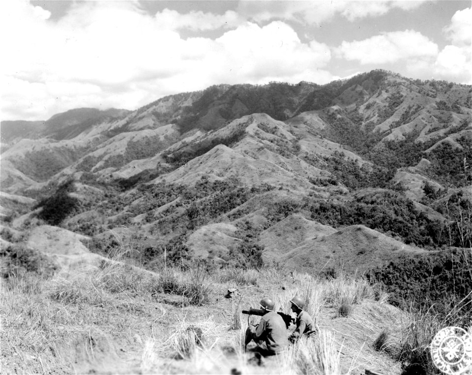 SC 364508 - L to R: Pfc. Waymen N. Ramply and Cpl. Perry Rowe(?), cal. .30 heavy machine gunners of the 127th Inf. Regt. supporting other elements of their Regt. on the Villa Verde Trail in the mountains between Sante Maria and Sant Fe, Luzon, P.I.