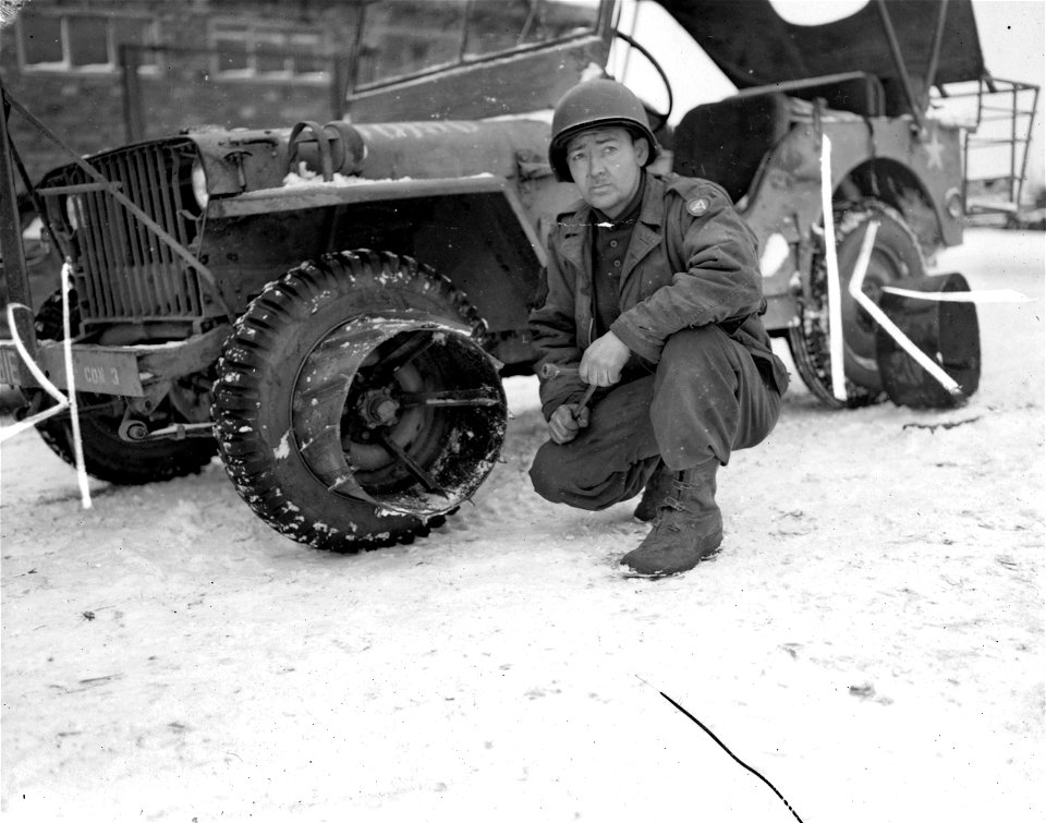 SC 199098 - Special mud shoe for wheeled vehicles found satisfactory for heavy going in Luxembourg after it was built by Engineer Maintenance Company. Right, T/4 Luther May, of Colorado Springs, Colo. 9 January, 1945.