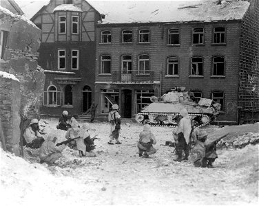 SC 199031-S - Troops of the 7th Armored Division on the lookout for snipers in the littered streets of St. Vith, Luxembourg. 23 January, 1945. photo