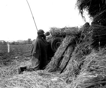 SC 195745 - This photo shows a GI relaying fire data for artillery back from forward observation post near Havert, Germany. 4 October, 1944. photo