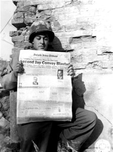 Cpl. Alfred B. Bergher, 15 E. 8th St., Duluth, Minnesota, reads a copy of his hometown newspaper. 26 January, 1945.