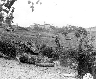 SC 270587 - Infantrymen of the 11th Armored Inf. Bn., moving toward the village of Bambiano a few minutes after it was occupied by leading units of the 11th Armored Inf. Bn.