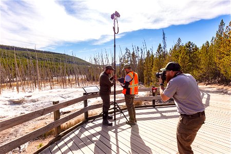 Photographing the geology team documenting Cistern Spring after a Steamboat Geyser eruption photo
