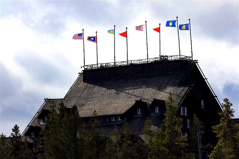 Yellowstone National Park Lodges 150 Years of Inspiration Event: Tribal, State, and US flags fly atop the Old Faithful Inn (2)