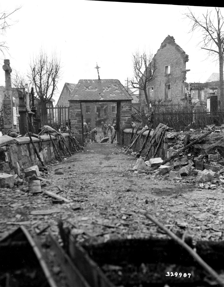SC 329987 - Infantrymen enroute to rest camp were sidetracked emergency road repair job to keep supplies moving to the front.