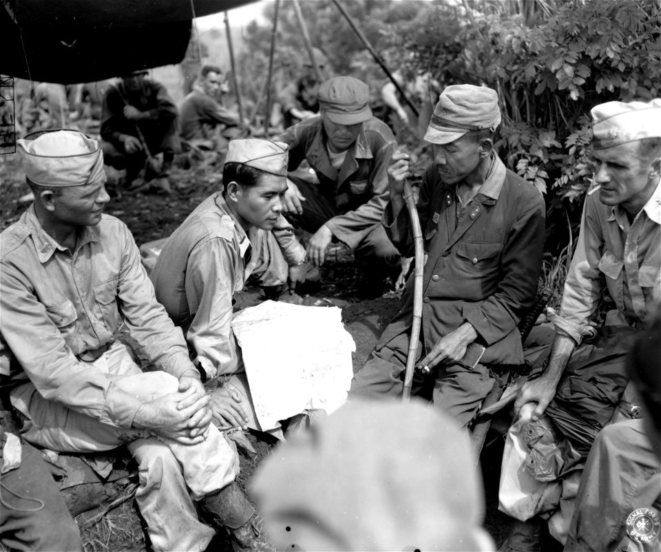 SC 211604 - (Clockwise) Lt. Clarence E. Rabb, Lt. Nisei, both of 38th Div., Lt. Col. Shizume Sushimi, Japanese Army, and Maj. Richard F. Jeffers, 38th Div., discuss surrender arrangements...