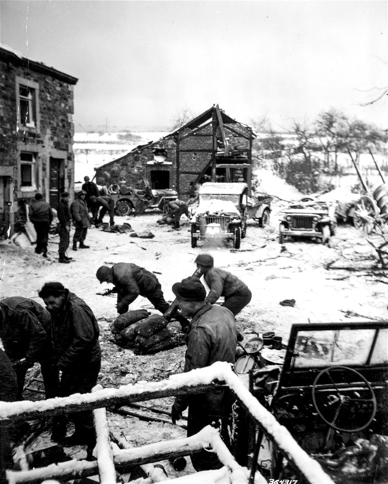 SC 364317 - Mortarmen of Company "D," 87th Chemical Battalion, 84th Division, receive fire orders while eating chow.