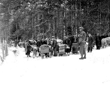 SC 199010-SA - Refugees wait at a cross road for the go-ahead signal from the M.P. photo