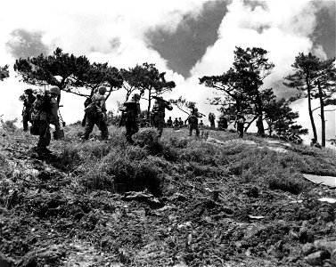 SC 270787 - Members of a machine gun section moving along hill to new position. Okinawa. 31 May, 1945. photo