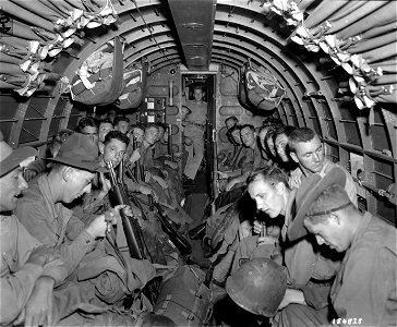 SC 184828 - Troops of the 163rd Infantry Regiment of the 41st Divsion are shown aboard a transport plane somewhere in New Guinea. 10 July, 1943. photo