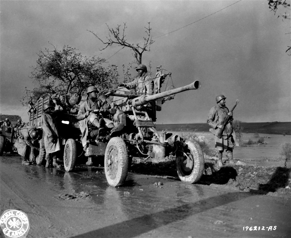 SC 196212-A-S - Members of an artillery unit stand by and check their equipment while convoy takes a break. E.T.O., 9 November, 1944.