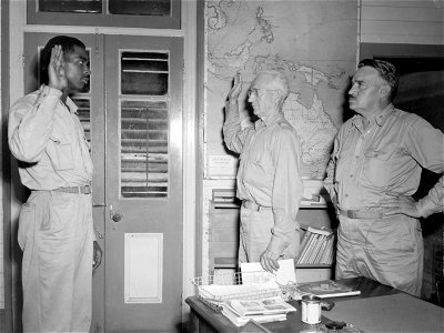 SC 364423 - Dr. Henry B. Hazard, representative of Naturalization and Immigration Service, administers Oath of Allegiance to Pfc. Franklyn E. Long, 689th Sig. Air Warning Co., the first man to be naturalized in Efate, New Hebrides.