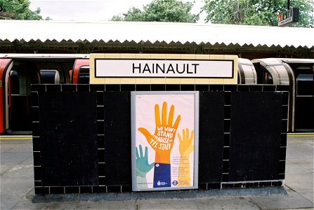 Old sign and modern poster at Hainault station photo