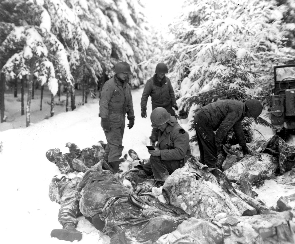 SC 199094-A - Graves registration officer identifies dead Yanks among Germans killed in Ardennes salient during 1st and 3rd Army squeeze against Von Rundstedt's lines. 11 January, 1945.