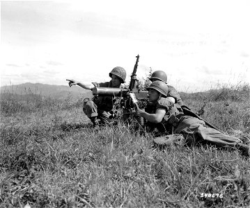 SC 348698 - Cpl. Ulysess J. Breaux of Breaux Bridge, La.; Cpl. Roy L. Guice of Rioneer, La.; and Pvt. David L. Cordova of Los Angeles, Calif., zero in their .30 caliber water-cooled machine gun on the line...