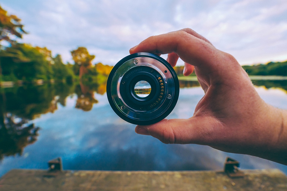Man Holding Camera Lens