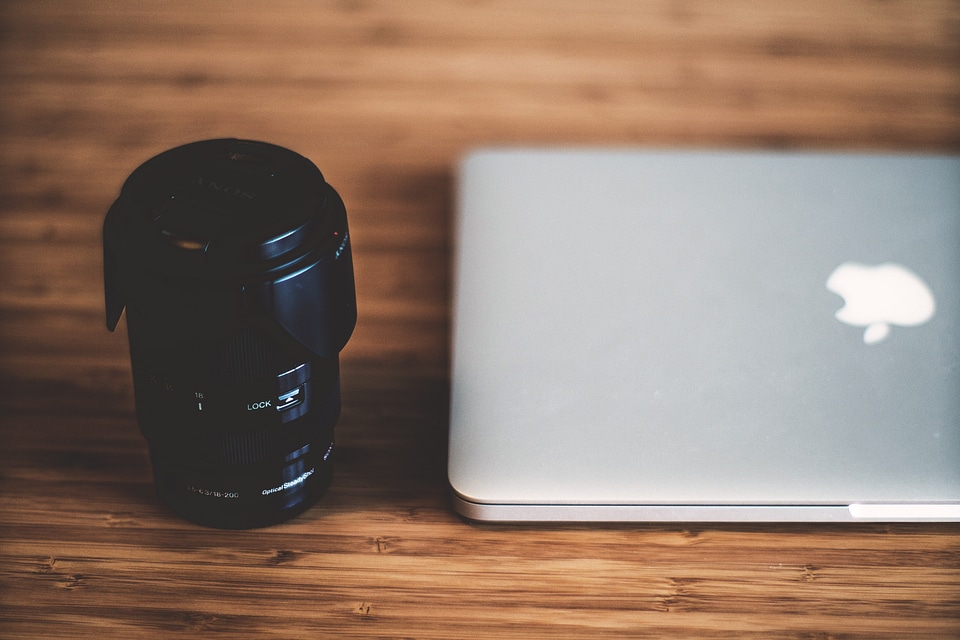 Canera Lens & MacBook Laptop on Wooden Desk