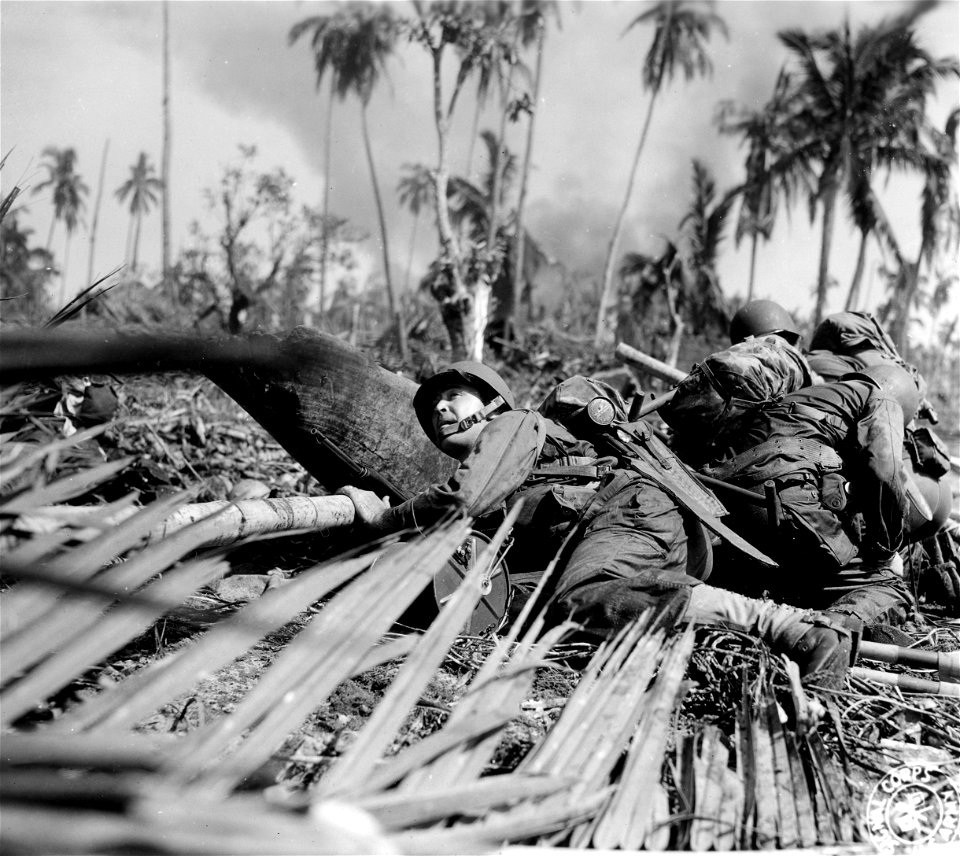 SC 374731 - U.S. soldier is forced to crouch low as enemy fire passes overhead just off one of the beaches on the east coast of Leyte island of the Philippines. 20 October, 1944.
