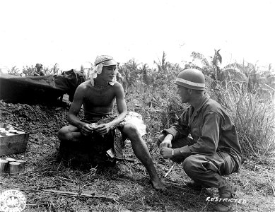 SC 335415 - John Schempf of Passaic, N.J., questions Joe Perez, native of Guam who escaped from Jap prison camp. 25 July, 1944.