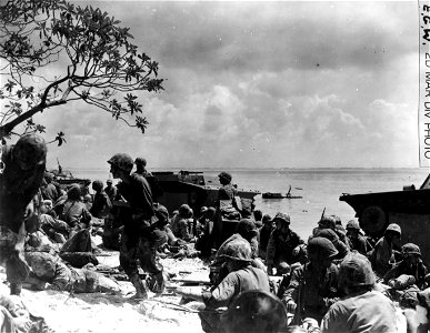 Marines of the assault wave on the beach. Stretchers have already been brought into play, although the battle is only a few minutes old.