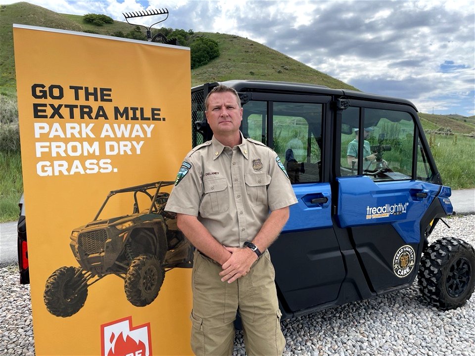 BLM State Fire Management Office posing in front of Fire Sense Sign