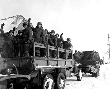 SC 199081 - A happy group of American soldiers wave "goodbye" as they leave assembly point, first departure point, on a trip home.