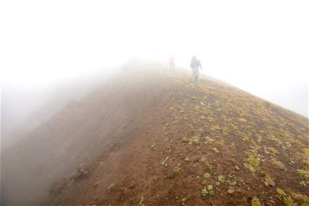 Backpackers on the east boundary line in cloudy conditions photo