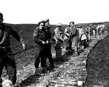 SC 196142-S - These South African troops in Italy have built this road out of 105mm shell cases, in order to pull their 40mm Bofors over it and into position to fire on the enemy.