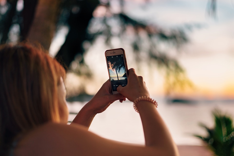 Woman Taking Photo on Beach